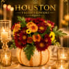 This arrangement holds a vibrant mix of burgundy and golden-orange chrysanthemums, accented