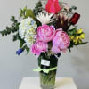 Large, lush pink peonies take center stage in this romantic flower arrangement
