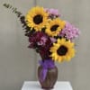 Three bold yellow sunflowers take center stage in this sunflower bouquet for