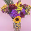 Bold sunflowers steal the show in this lively birthday bouquet, a garden-style