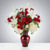 Bold red roses and pure white lilies come together in a lush