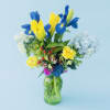 Vivid blue iris and bright yellow tulips create an uplifting focal point