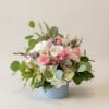 A lush cluster of blush and white roses paired with pale hydrangeas