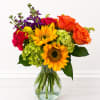 Vivid orange roses and golden sunflowers take center stage in this cheerful