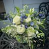 White and blue mixed bouquet in a glass vase