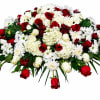 A broad, low casket spray that speaks with quiet dignity-Eternal Grace is