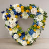 A lush heart-shaped wreath of flowers that speaks of lasting affection-the perfect