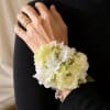 Soft clusters of ruffled small flowers like spray roses, lisianthus form a