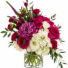 Bold magenta roses meet fluffy white carnations and jewel-toned purple chrysanthemums in