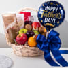 A gift basket filled with fresh fruit and chocolates. The basket contains