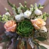 Peach and white roses with snapdragons and a green succulent in a wooden container