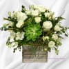 White roses and alstroemeria in a rustic square vase with a green succulent