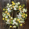 Bright and uplifting, this standing wreath features a cheerful blend of yellow