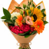 A bold yellow sunflower steals the show in this hand wrapped bouquet-an