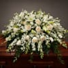 A serene cascade of cream and white roses, white lilies, and delicate