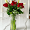 Tall white calla lilies rising above deep red roses create a striking