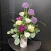 White roses and lavender chrysanthemums mingle with round purple allium-like blooms in