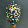 A dramatic standing spray that speaks with quiet dignity, arranged for sympathy