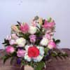 A fresh and elegant arrangement featuring white roses, pink lilies, and complementary