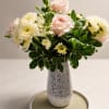 A graceful vase arrangement featuring soft blush roses, white chrysanthemums, snapdragons, and
