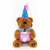 A cuddly brown teddy bear dressed for a birthday celebration greets the