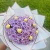 Lavender rose bouquet with gold-wrapped chocolates and a small card