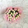 Bouquet of pink and cream tulips wrapped in pale pink paper