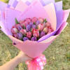 Bouquet of pink and purple tulips wrapped in pastel paper