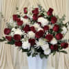 Dense clusters of deep red roses paired with crisp white blooms create