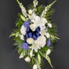 Dark Blue Delphinium and Daisy Poms are accompanied by White Oriental Lilies