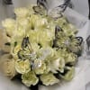 A cluster of pale yellow roses gathered into a rounded hand-tied bouquet