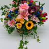 Mixed flower basket with pink lilies, roses, and sunflowers