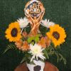 Sunflower and white daisy arrangement in a soccer-themed vase with a Best Dad topper