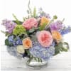 Garden rose, ranunculus, blue hydrangea and more in a car round cylinder