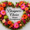 This heart-shaped sympathy arrangement offers a lush, handcrafted tribute for honoring a