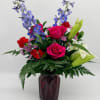 A bright and heartfelt mix of roses, lilies, accent flowers, and fresh