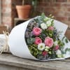 Clustered pink roses paired with soft white lisianthus and delicate lavender filler