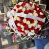 Large bouquet of red and white roses with a tiara and ribbon
