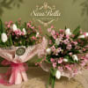 A graceful bouquet of crisp white tulips and delicate pink blossoms, beautifully