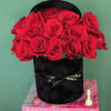 Red roses arranged in a black hatbox with a ribbon
