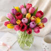 A lively halo of pink, red, yellow, and purple tulips creates an