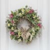 A 22&rdquo; diameter wreath made of all artificial flowers to withstand outdoor