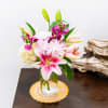 Pink lilies and chrysanthemums in a glass vase