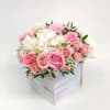 Pink and white roses with hydrangeas in a white wooden box
