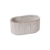 A collection of ribbed ceramic vessels with a soft ivory glaze and