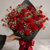 Deep, sensual red roses and clustered red carnations make an immediate statement
