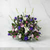 A lush, garden-style arrangement featuring elegant white lilies and calla lilies surrounded