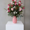 A vibrant mix of pink roses, paired thoughtfully with white chrysanthemums and
