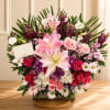A beautifully crafted sympathy arrangement featuring premium seasonal blooms in shades of