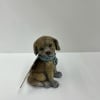 Small decorative dog figurine with a blue collar